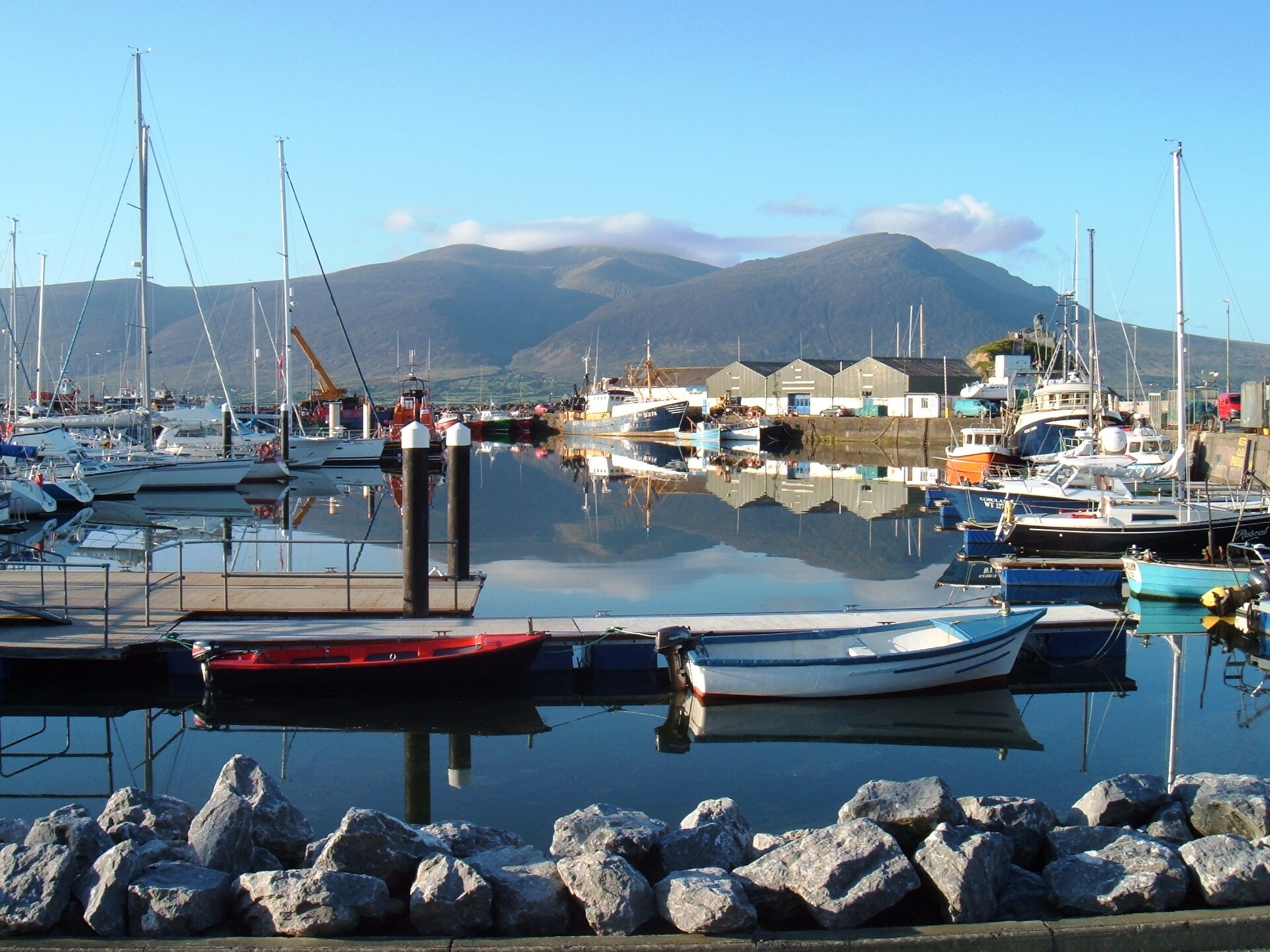 Moored boats at Fenit Harbour in Tralee Bay, with the Slieve Mish Mountains beyond.